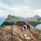 A young woman explores the coastline of Madeira